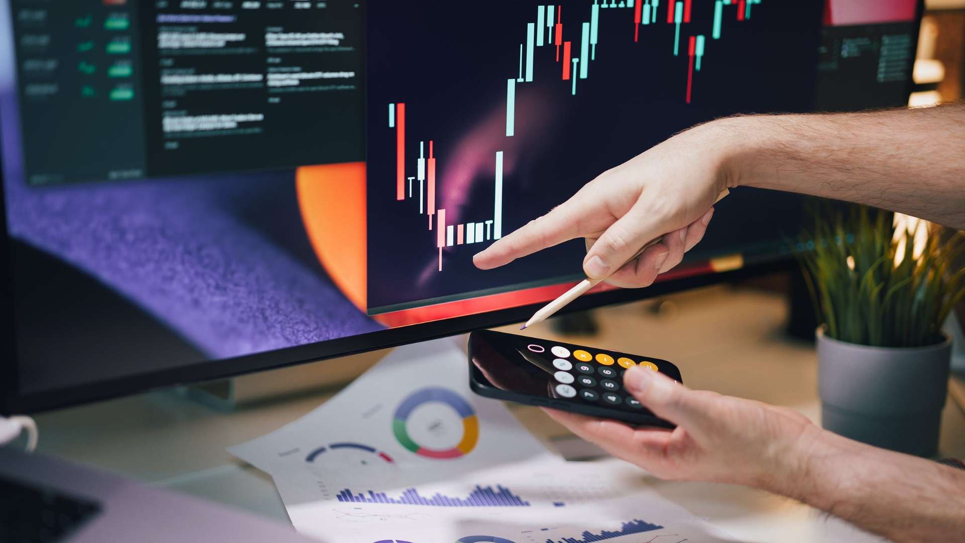 Person reviewing stock performance charts and financial data representing employee stock ownership and business valuation planning.